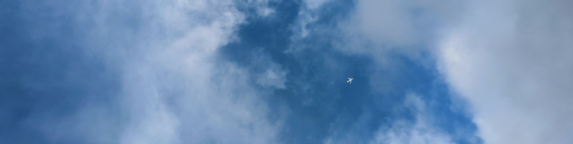 Photograph of an airplane flying through the sky with no contrails behind it