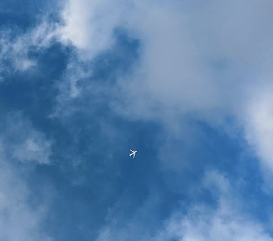 Photograph of an airplane flying through the sky with no contrails behind it