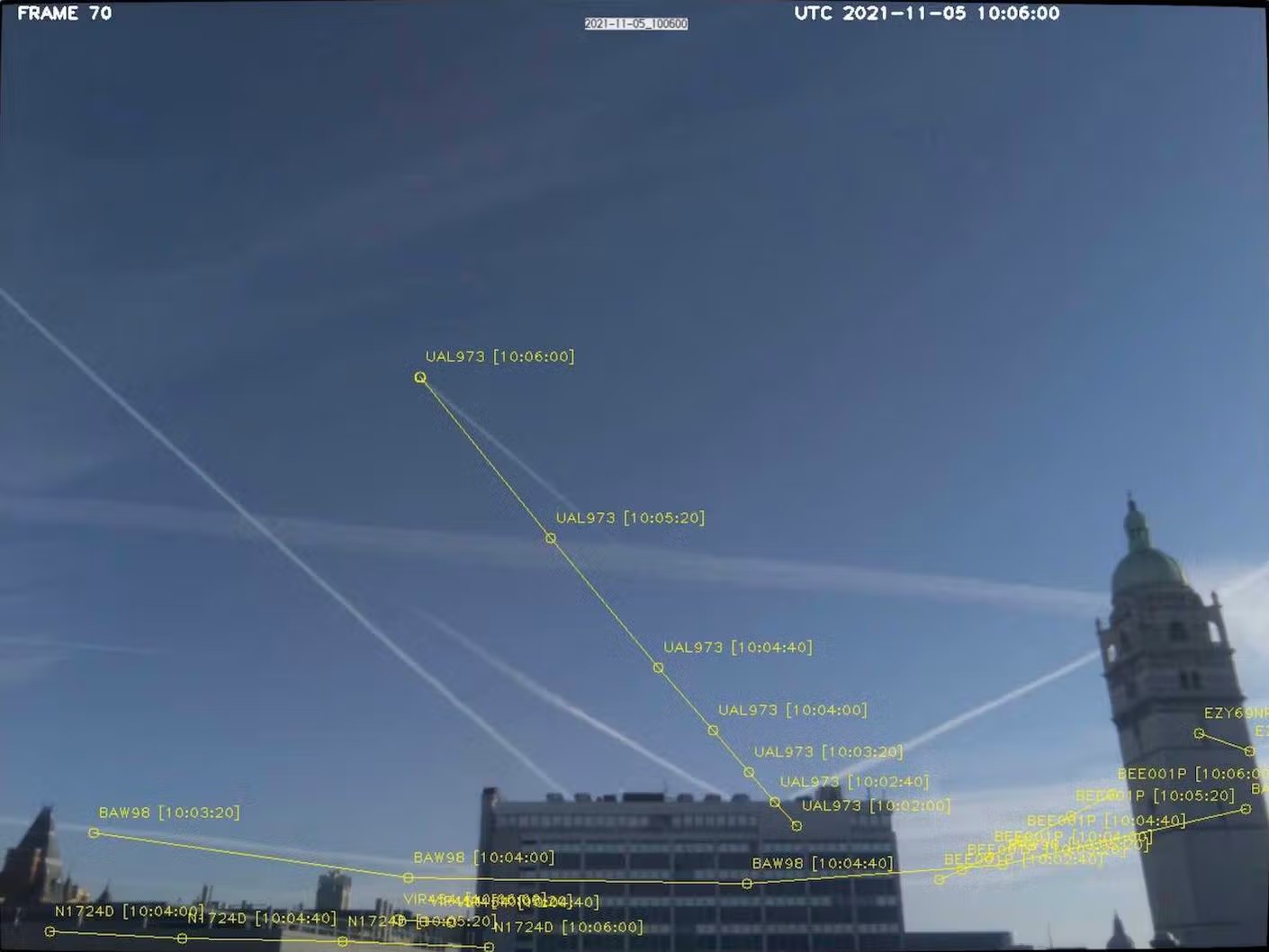 A image of a variety of contrails, where specific flight information has been overlaid on top of each contrail.